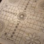 Close up image shot of engraved, wooden ludo board game with wood-stained borders and geometric flower design.